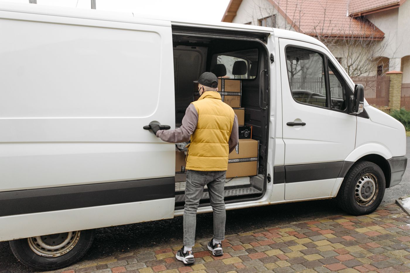 Driver loading boxes into a white van