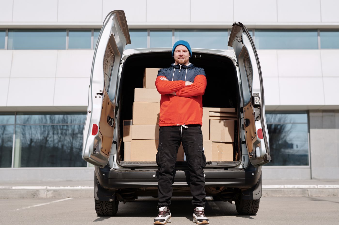 Driver standing in front of a van full of boxes